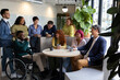 © Aida - Multiracial and multigenerational colleagues enjoying coffee break in coworking space