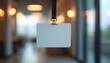© Vadym - Blank white ID badge hanging lanyard against blurred office background. Identification card for security, access control, employees. Corporate event, conference, meeting, seminar. Blank template,
