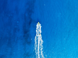 Wall Mural - vacation and leisure. seascape with motorboat. aerial view on fast boat on blue sea at sunny day. fa