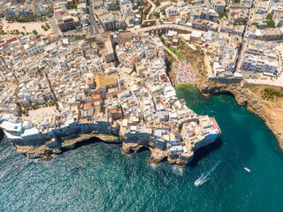 Wall Mural - polignano a mare, italy. beach between the rocks. aerial view of the city. old buildings on a cliff 