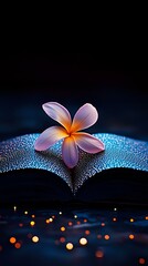 Poster - Pink plumeria flower on open book with water drops and bokeh lights creating magical atmosphere against dark blue background, romantic evening mood.