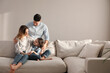 © New Africa - Family with little daughter resting on sofa in living room