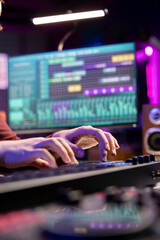 Aufkleber - Sound engineer working with soundboard and midi controller to create the perfect tunes for his songs, recording and editing audio. Music composer adjusts volume levels during mixing sessions.
