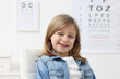 © New Africa - Portrait of cute little girl at ophthalmologist office. Eye examination