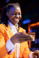Poster - Happy woman excited to do internet shopping, typing debit card information on laptop in apartment. Joyous person with candid smile at desk using notebook, adding payment method on website