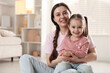 © New Africa - Family portrait of beautiful mother with little daughter at home. Space for text