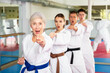 © JackF - Adults in kimono trying new martial moves at karate class