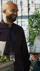 Poster - vertical video relaxed multiethnic coworkers in office having fun chatting while reviewing documents