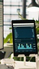 Poster - vertical video modern workspace with key performance indicators data on display in bright office env