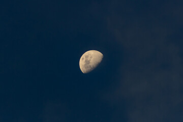 Wall Mural - the moon in the dark blue sky with clouds. the lunar eclipse.