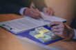 © Panumas - Businessman presents company's financial policy plan for request a loan of funds from a banker. Selected focus