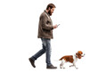 © BondGraphics - Man Walking Dog, Phone, Isolated on Transparent Background, Beagle, Full Body, Studio Shot, Dog, Person, Smartphone