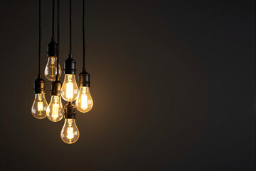Poster - Hanging vintage Edison light bulbs glowing warmly in dark background.