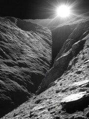 Wall Mural - Dramatic lunar landscape with sunburst illuminating a deep canyon in monochrome space exploration