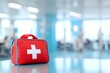 © ngalong project - Red first aid kit with white cross on a blue surface in a room.