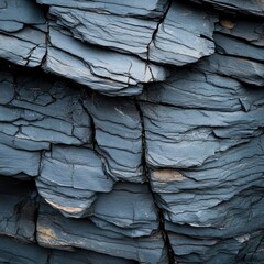 Poster - Striking close up of dark blue layered rock formations creating a unique abstract pattern and texture for geological exploration and nature photography