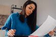 © Ljustina - Focused woman managing home finances and calculating expenses