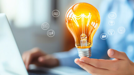 Aufkleber - A person holding a glowing light bulb symbolizing innovative ideas and creativity in a digital workspace.