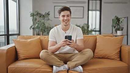 Poster - A person sitting on a sofa looking at their smartphone