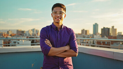 Poster - A person stands at the rooftop edge, arms crossed, conveying determination or defiance