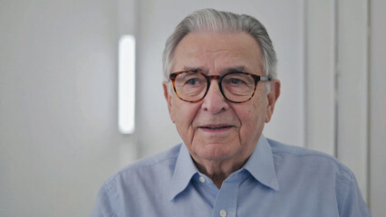 Poster - Older man wearing glasses and blue shirt in formal setting
