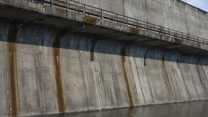 Poster - Concrete wall with a bridge crossing over it