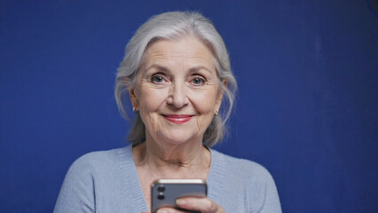 Poster - A woman holding a cell phone, possibly checking messages or making calls