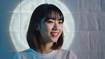 Poster - A woman is smiling in front of a circular light