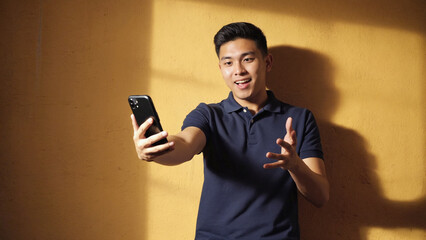 Poster - A person holding a mobile device in his hand