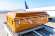 © UraiwanT - Coffin on airport tarmac, wooden casket placed on luggage cart, somber context highlighting transport and farewell.