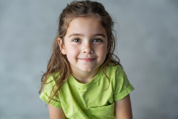 Poster - Portrait of smiling young girl in green shirt with soft light and abstract background in studio setting. Ai generative.