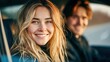 © NovaVision - A beautiful woman smiles brightly, sitting in a car with a friend, enjoying the moment.