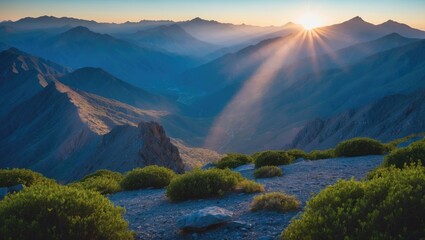 Poster - Sunlight rays shining over the mountain range in a landscape with space for text.