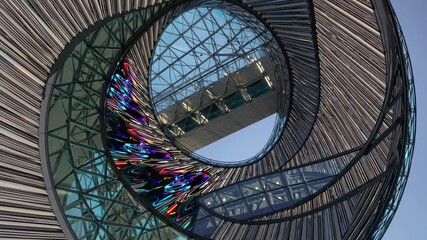 Poster - futuristic metal and glass circular building with colorful led screen displaying abstract digital ar