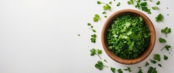 Aufkleber - Wooden bowl filled with chopped parsley leaves, seen from above against a white background