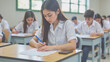 © DruZhi Art - High School Student Taking Final Examination – Asian Teenager in White Uniform Writing with Blue Pen for Education Content, Academic Achievement, and Passed Test Celebrations