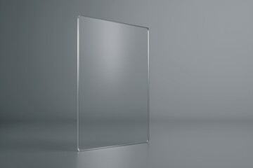 Poster - transparent glass screen resting on a gray background, enhancing a sleek and modern aesthetic throug