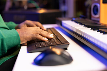 Aufkleber - Male artist editing his recorded music in post production, working with a professional software on computer in home studio. Young sound engineer producing tunes for the music industry. Close up.