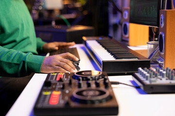 Aufkleber - Audio technician working with a professional editing software on pc, mixing and mastering his old songs recordings in home studio. Musician uses stereo equipment and amplifier. Close up.
