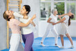 © JackF - Two young women practicing self-defense techniques in group at gym