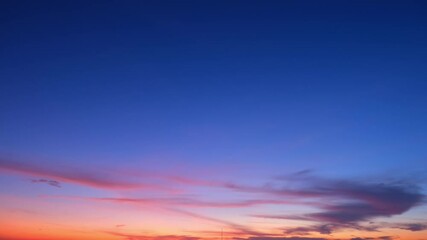 Wall Mural - 4K: A time lapse of the sunrise offers a glimpse into the dynamic and colorful world above, as clouds paint a picture of tranquility and beauty.
