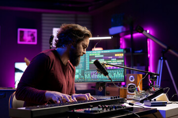 Aufkleber - Sound engineer working in home studio with daw software interface, playing piano notes and editing audio recordings. Performer creating tunes on electronic midi controller keyboard.