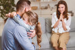 © Prostock-studio - Daughter's Love. Cheerful Wife Looking At Husband And Their Kid Girl Embracing At Home. Selective Focus