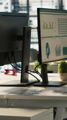 Poster - vertical video business graphs and performance metrics on monitors in workplace, handheld camera sho