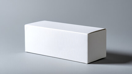 Poster - A rectangular white box sits on a gray surface with a soft shadow behind it in a studio setting