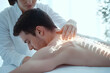 © Earny - A professional therapist provides a soothing spinal adjustment to a male client, promoting relaxation and healing.