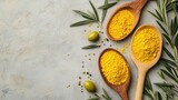 Wooden spoons with turmeric powder, olives, and herbs on a textured background.  Possible use Food photography, cooking blog, spice market