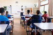 © wavebreak3 - Indian female teacher presenting in classroom, students listening attentively in school setting