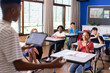 © wavebreak3 - Presenting project on tablet, student engaging classmates in school activity