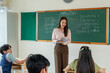 © Kawee - Asian female teacher teaching young kid students in elementary school.